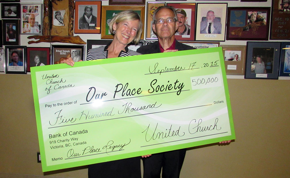 Susan Haddon, Board Chair of Our Place Society, accepts legacy donation from Rev. Bill Cantelon, past chair of Victoria Presbytery